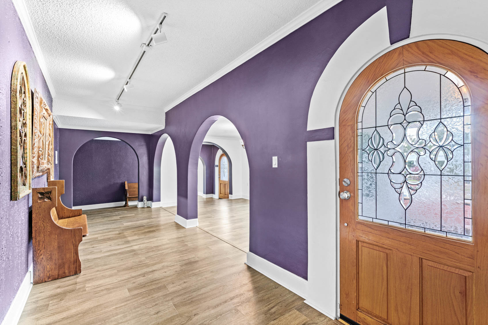 inside front wooden door with purple hallway